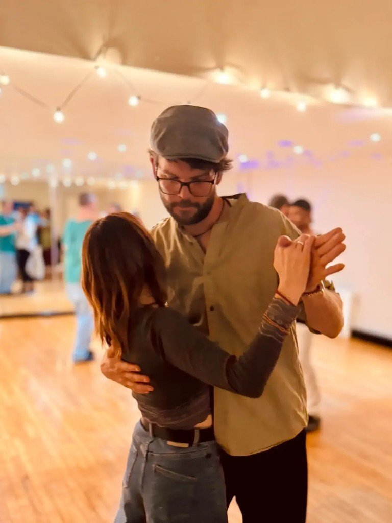 Couple dancing under warm studio lights